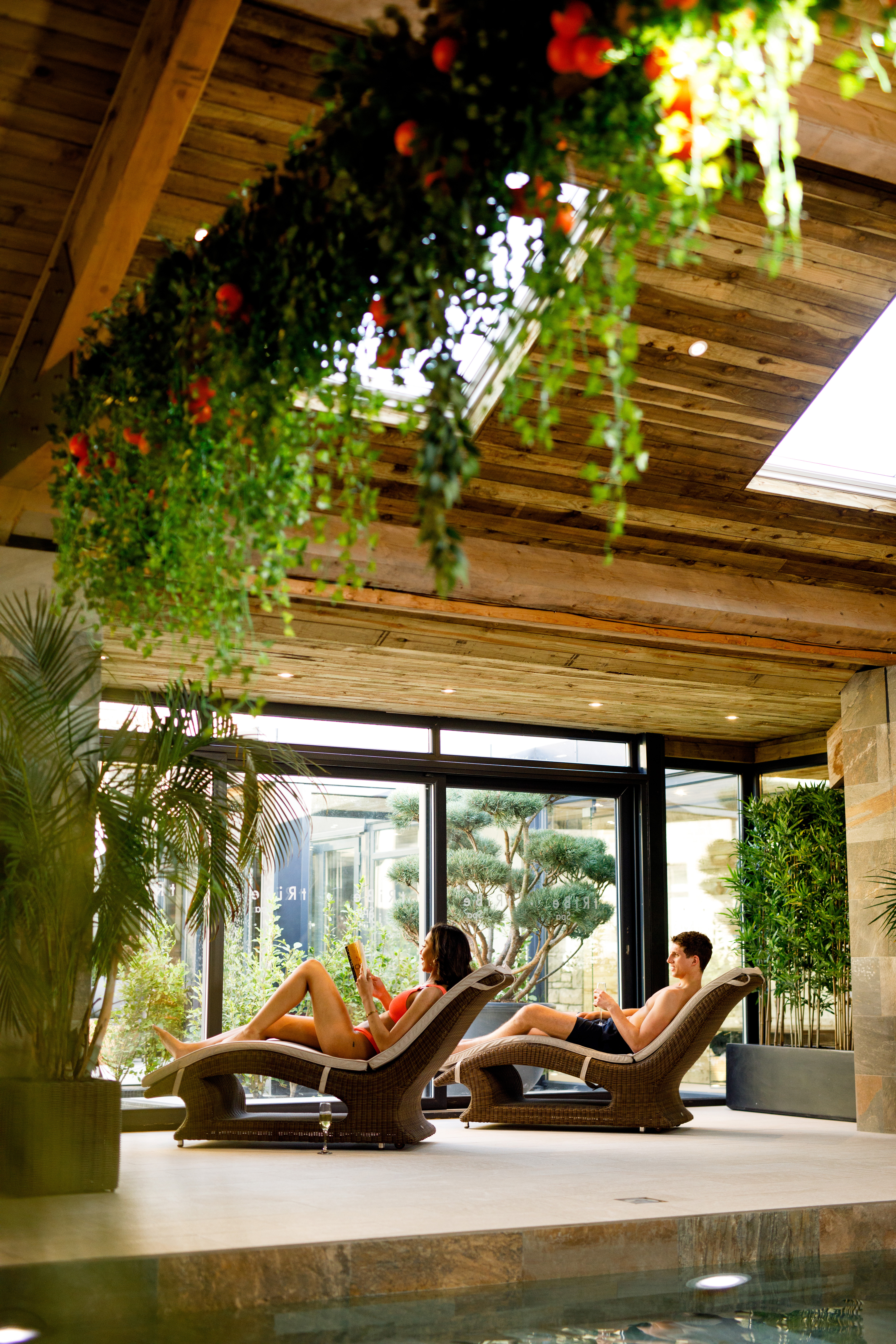 People relaxing on loungers at Lanelay Hall Hotel & Spa